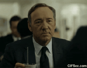 frank underwood gives a sarcastic look at the camera